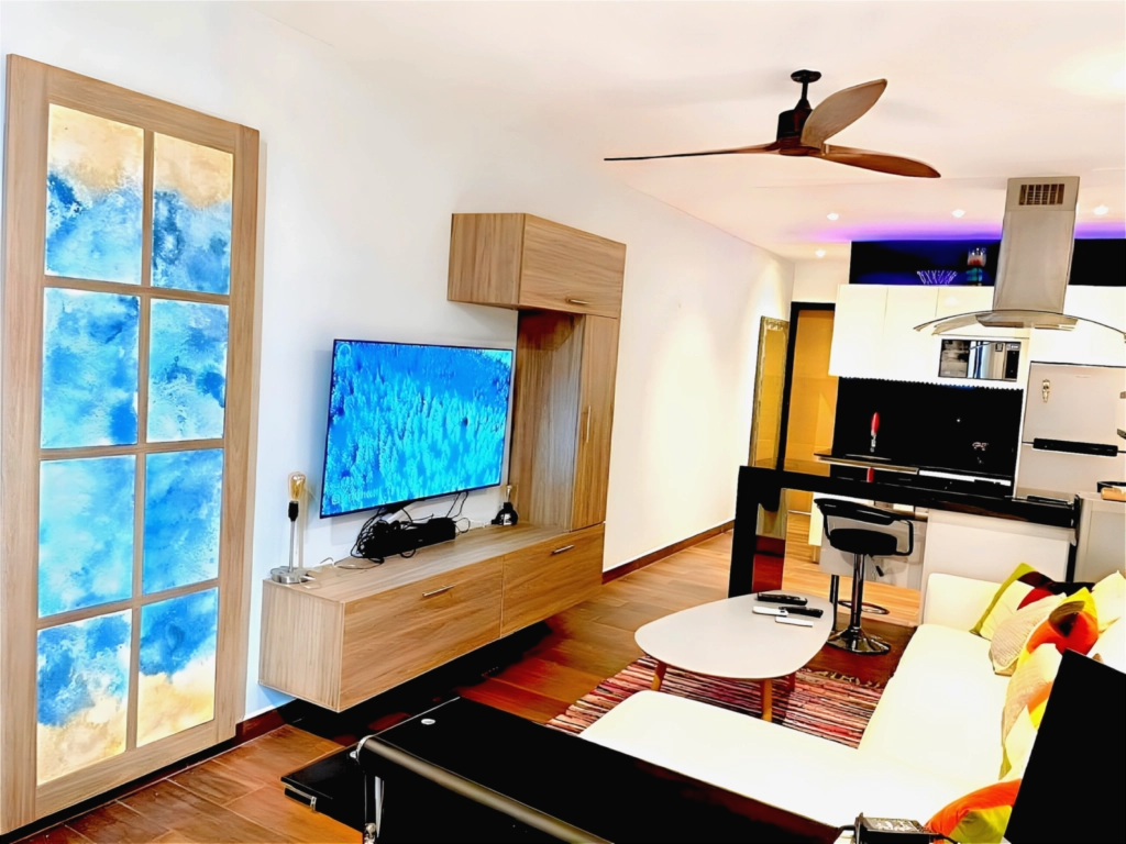 Un espacio moderno y acogedor con salón y cocina totalmente equipada Salón moderno y luminoso con cocina abierta y zona de estar en Playa del Carmen