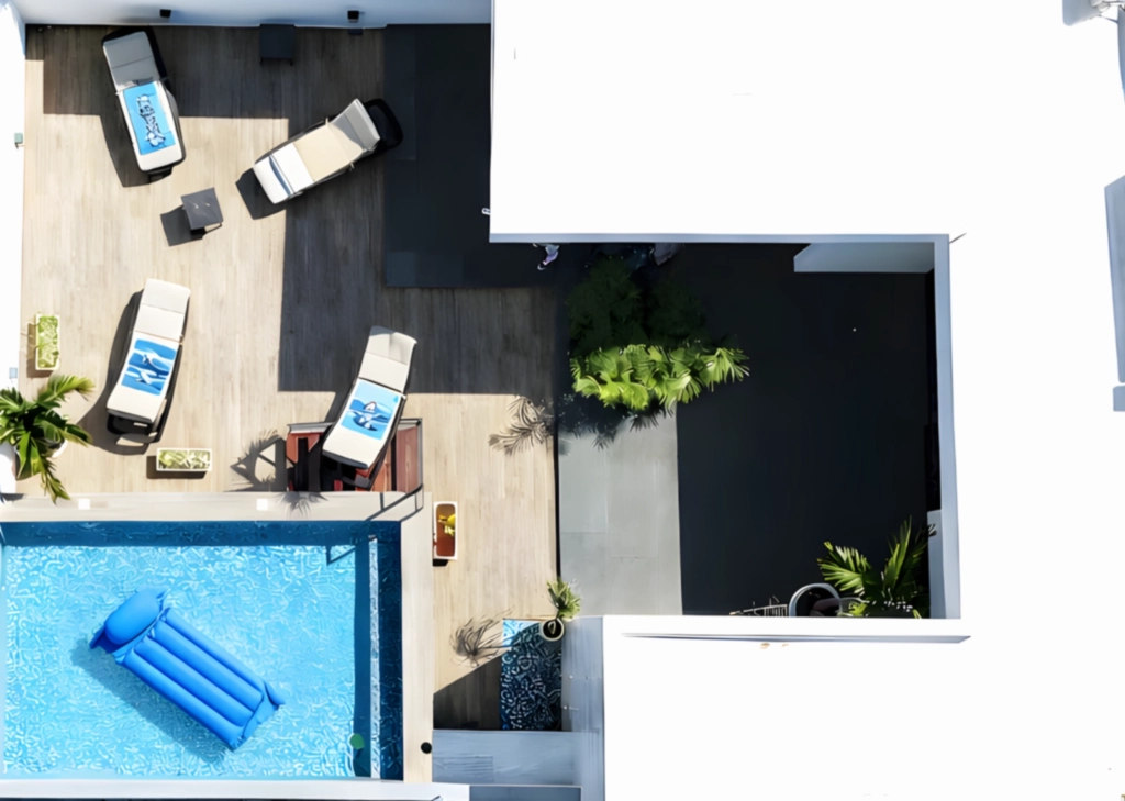 Rooftop Pool & Relaxation Area – Vedra Suite Playa del Carmen Aerial view of the rooftop pool with sun loungers and relaxation area at Vedra Suite in Playa del Carmen