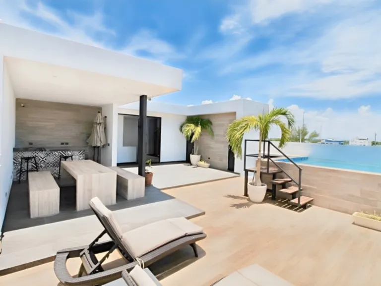 Sunny  terrace with sun loungers and ocean view in Playa del Carmen