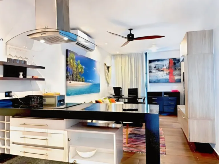 Modern open-plan kitchen with breakfast bar in Playa del Carmen vacation apartment